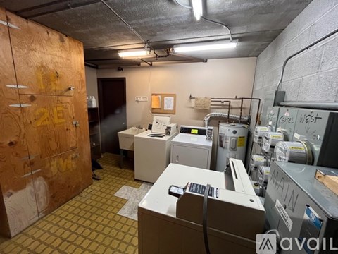 A room with a lot of electrical equipment and a wooden door with the number 23 on it.