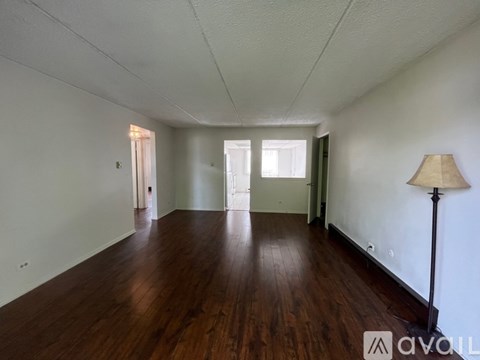 A room with wooden floors and white walls.