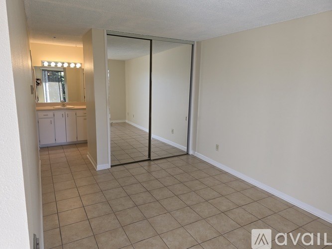 A room with a sliding door and a mirror on the wall.