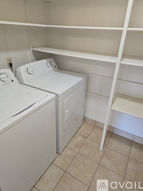 A small laundry room with a washer and dryer.