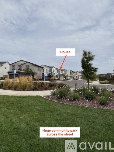 A house is located in a neighborhood with a huge community park across the street.