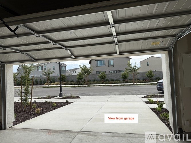 A view from a garage looking out to a residential area.
