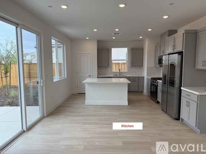 A kitchen with a white island in the middle of the room.