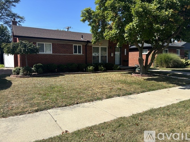 A house with a tree in front of it.