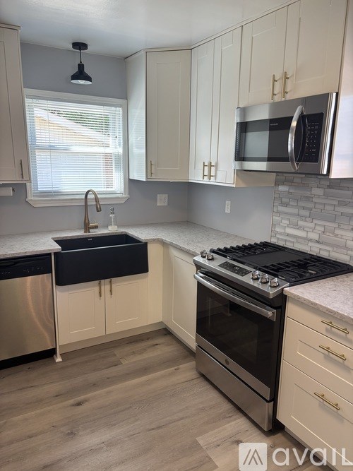 A kitchen with a stove top oven and a microwave above it.