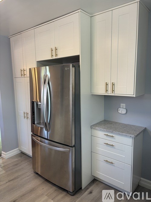 A stainless steel refrigerator with a freezer on top and a drawer at the bottom.