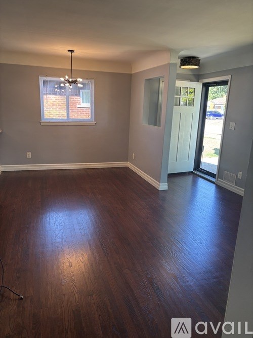A room with wooden floors and a window.