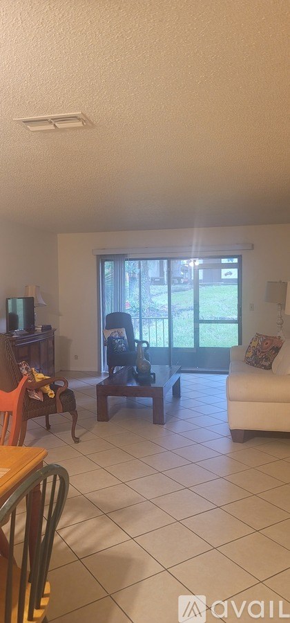 A living room with a white couch and a television.
