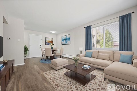 A living room with a beige couch, a coffee table, and a painting on the wall.