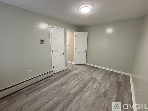 A room with a grey floor and white walls.