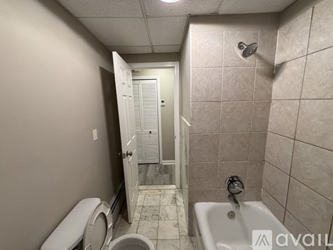 A bathroom with a toilet, sink, and shower.