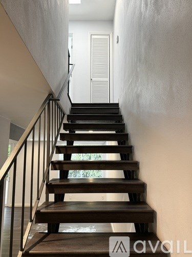 A staircase with wooden steps and metal railings.