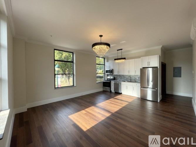 A spacious kitchen with wooden floors and a large island.