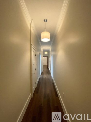 A long hallway with a light at the end.