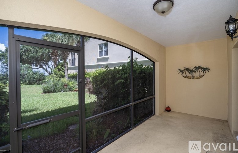 A room with a sliding glass door leading to a garden.