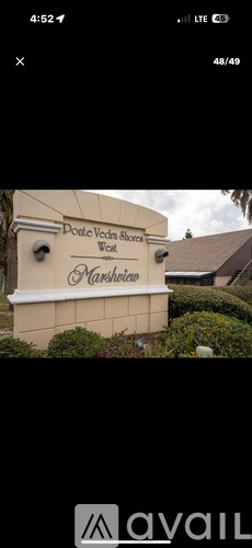 A sign that says "Dove Vine Estates" is in front of a building.