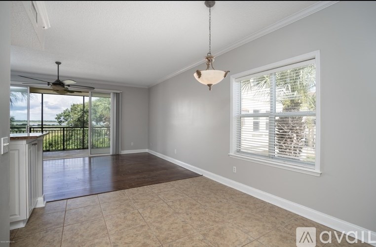 A room with a ceiling fan and a hanging light fixture.