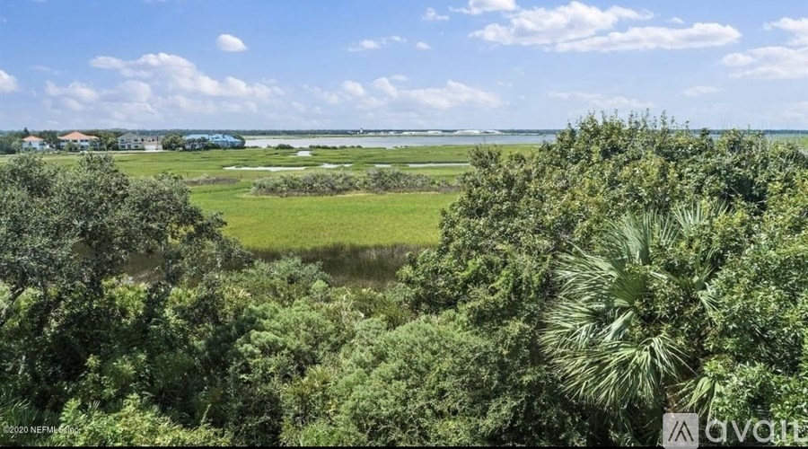A lush green landscape with a body of water in the distance.