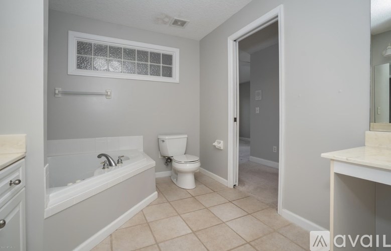 A bathroom with a toilet, sink, and bathtub.