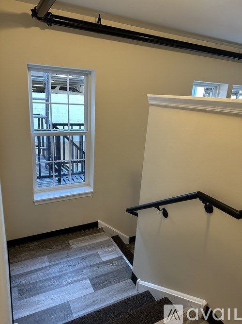 A room with a window and a staircase.