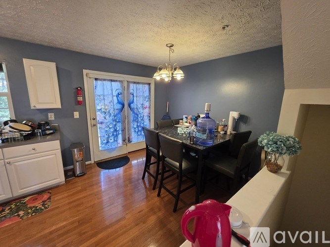A kitchen with a dining table and chairs.