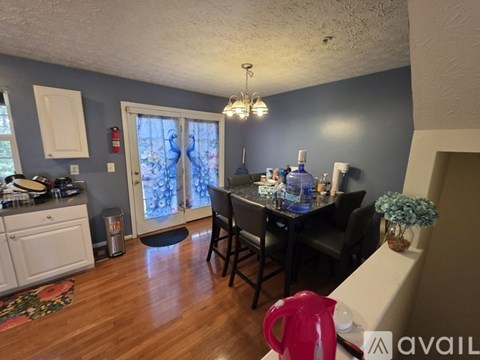 A kitchen with a dining table and chairs.
