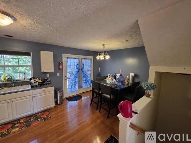 A kitchen with a dining table and chairs.