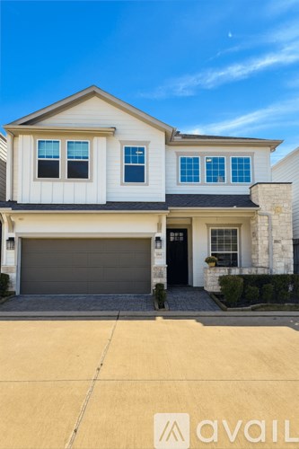A two-story house with a garage is available for sale.