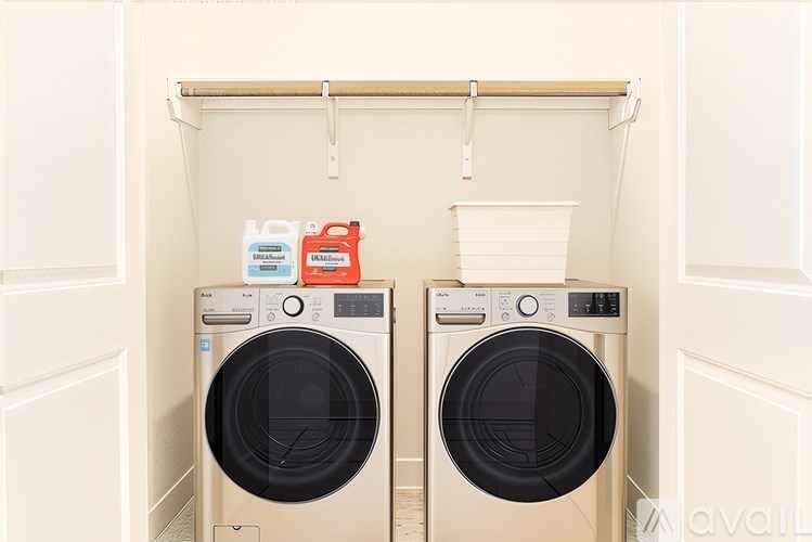 Two washing machines are in a cabinet.