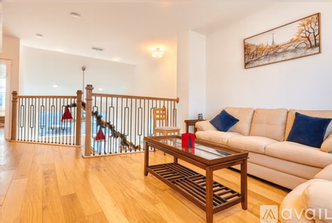 A living room with a white couch and a wooden coffee table.