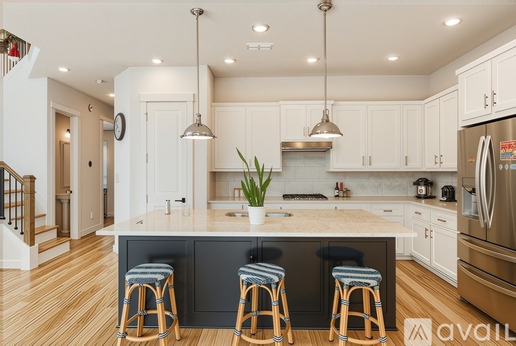 A kitchen with a center island and bar stools.