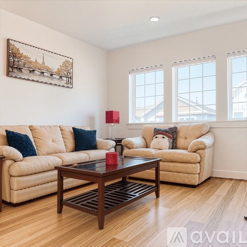 A living room with a couch, chair, and coffee table.
