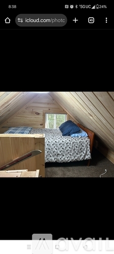 A bedroom with a bed and a window.