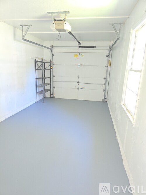 A white room with a ladder and a window.