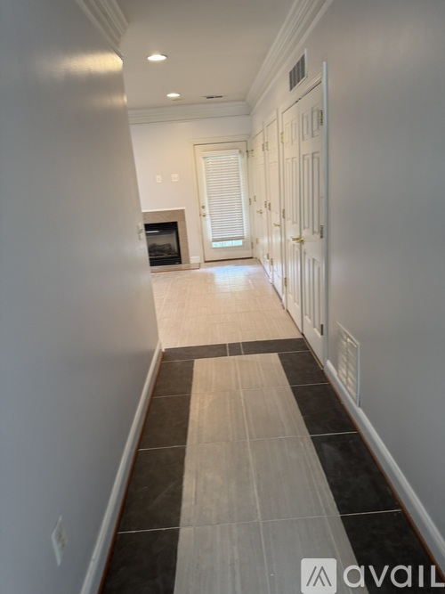 A long hallway with a black and white striped tile floor.