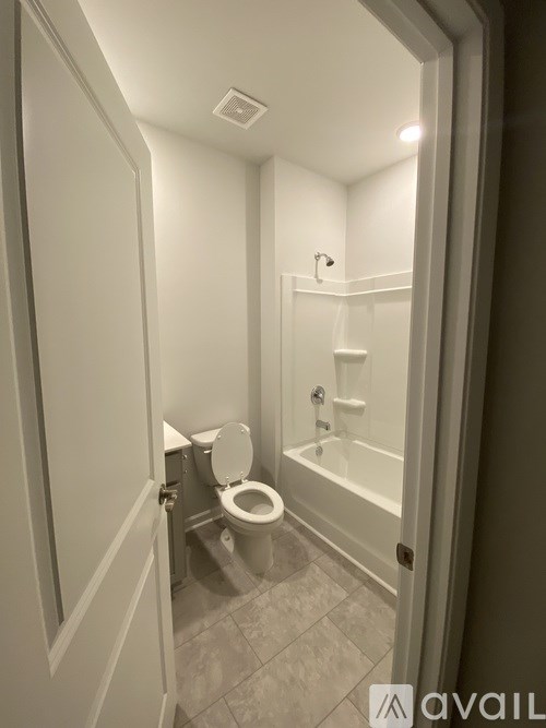 A small bathroom with a toilet and a bathtub.