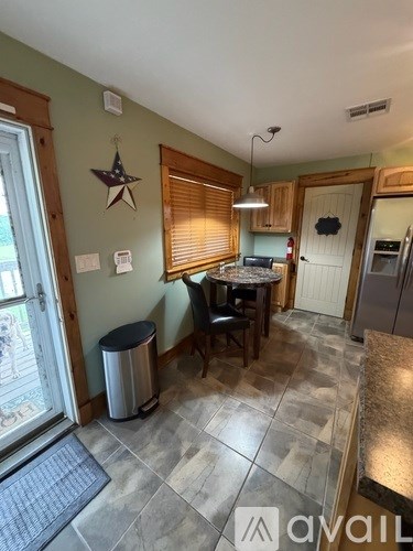 A kitchen with a table and chairs in the middle of the room.