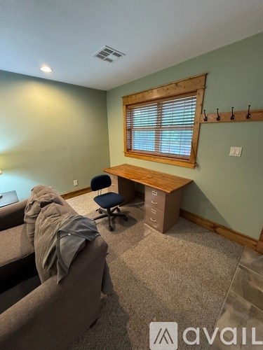 A room with a desk and a chair.
