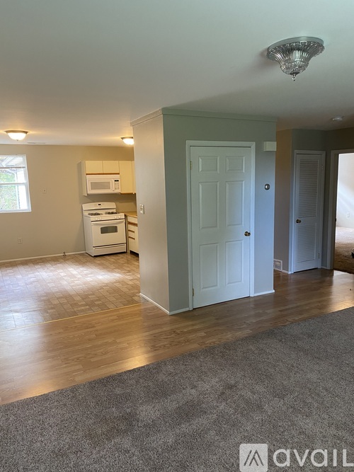 A kitchen area with a white oven and microwave.