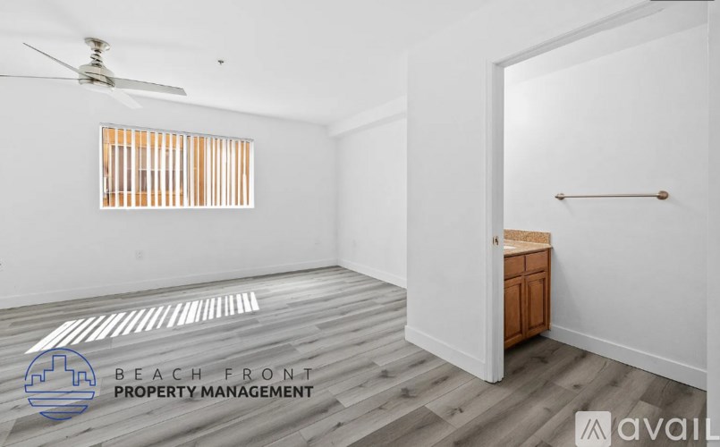 A room with a ceiling fan and a window with wooden blinds.