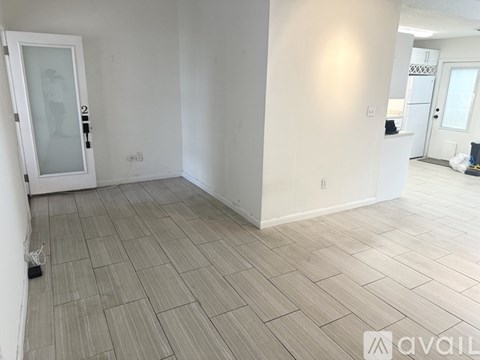 A living room with a brown leather chair and a television.