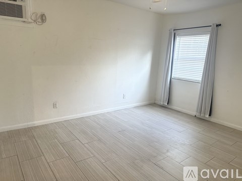 A room with a window and a sliding door.