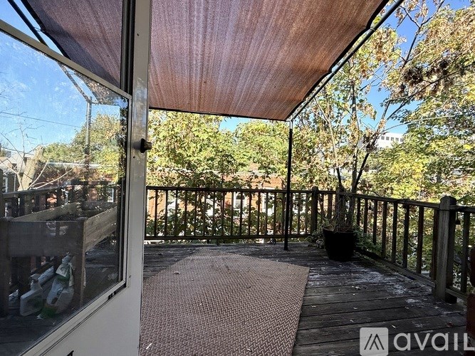 A kitchen with wooden floors and a brick wall.