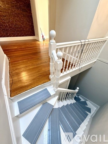 A staircase with a white railing and wooden steps.