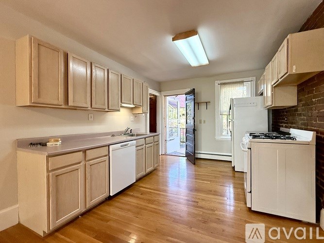 A room with wooden floors and a ceiling fan.