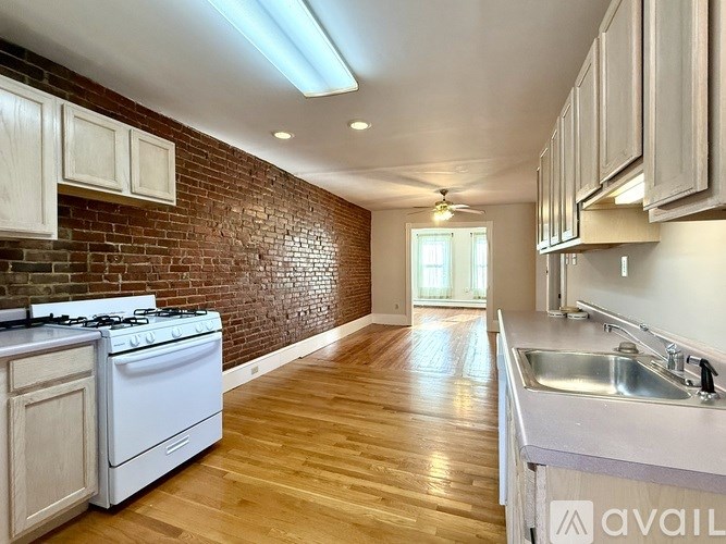 A wooden deck with a brick building in the background.