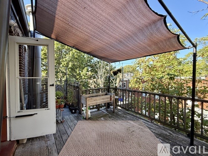 A kitchen with wooden floors and white appliances.