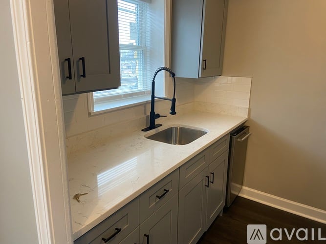 A kitchen with a sink and a window.