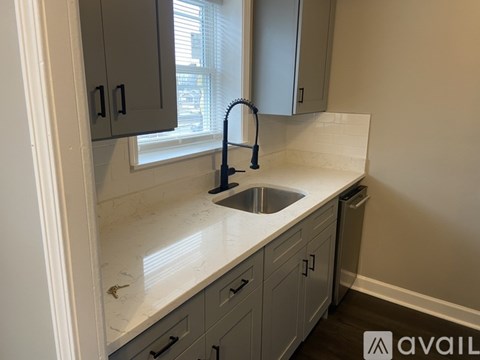 A kitchen with a sink and a window.