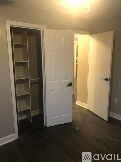 A white door is open to a hallway.